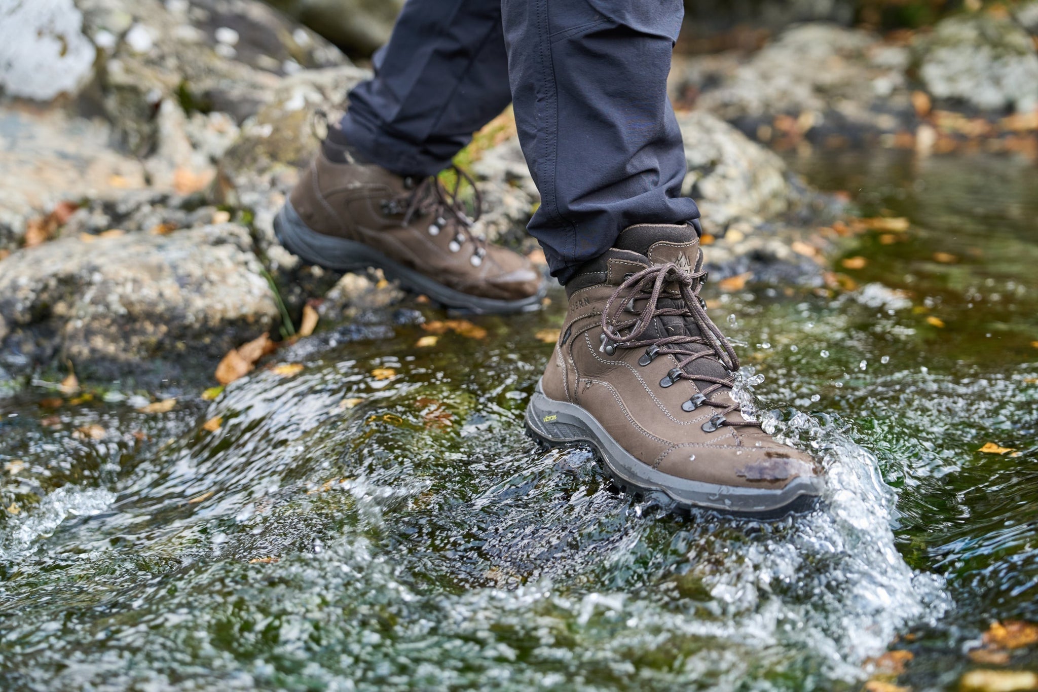 Fjern hiking boots splashing through a stream