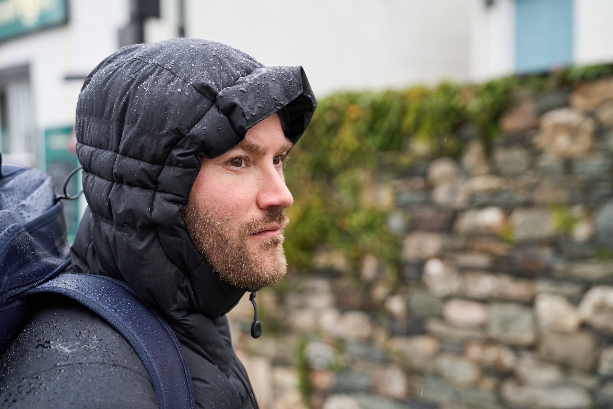 Close-up of a person in a black Aska jacket in the rain